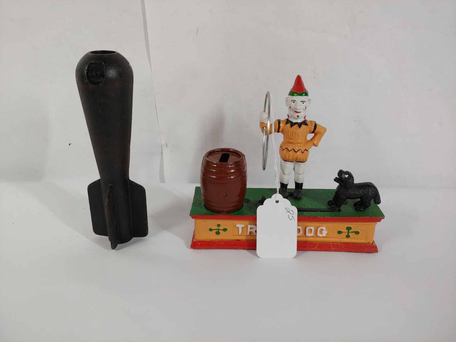Trick Dog mechanical bank & mini cast iron practice bomb: Both are 8in long.