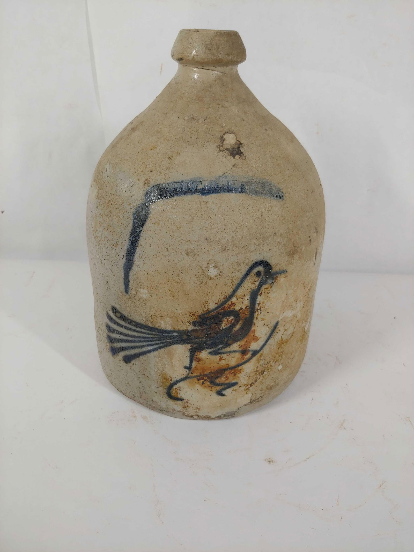 Whites Utica 1-gal stoneware bird jug: With a broken handle. 10.5in tall.