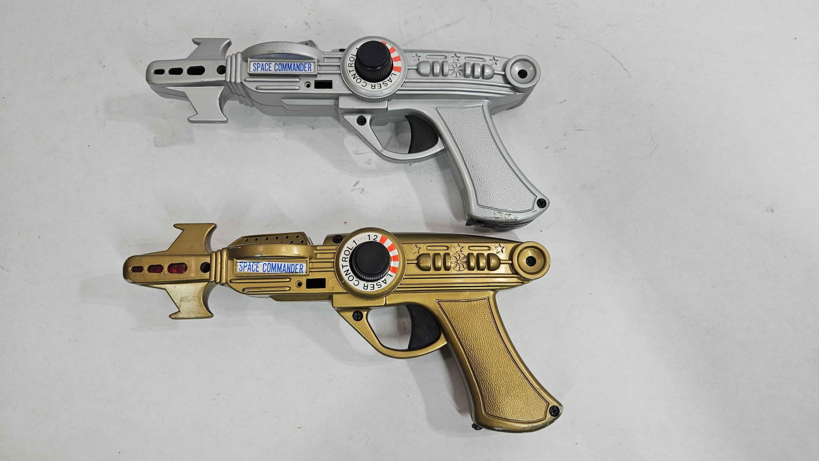 SPACE COMMANDER LASER CONTROL GUNS: LOT OF TWO. BOTH LIGHT UP AND WORK GREAT.