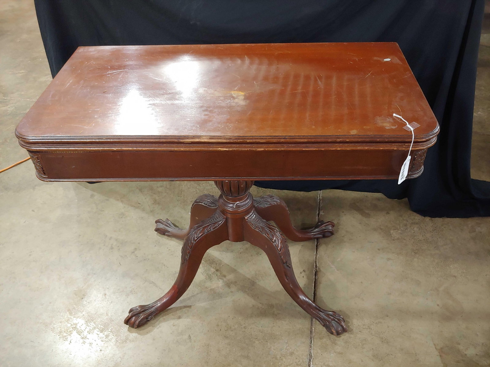 CLAW FOOT TABLE WITH LEAF: LEAF UNFOLDS AND ROTATES ON BASE. WHEN OPENED, 38X38. TOP IS 19X38 WHEN CLOSED. THERE IS STORAGE UNDER LEAVES