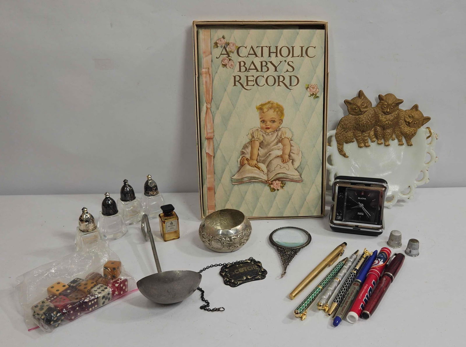 PERFUME BOTTLES, DICE, CATHOLIC BABY BOOK AND SMALLS: MISC LOT OF GOOD EARLY ITEMS. INCLUDES SCOTCH METAL TAG, BULOVA ALARM, AND MORE