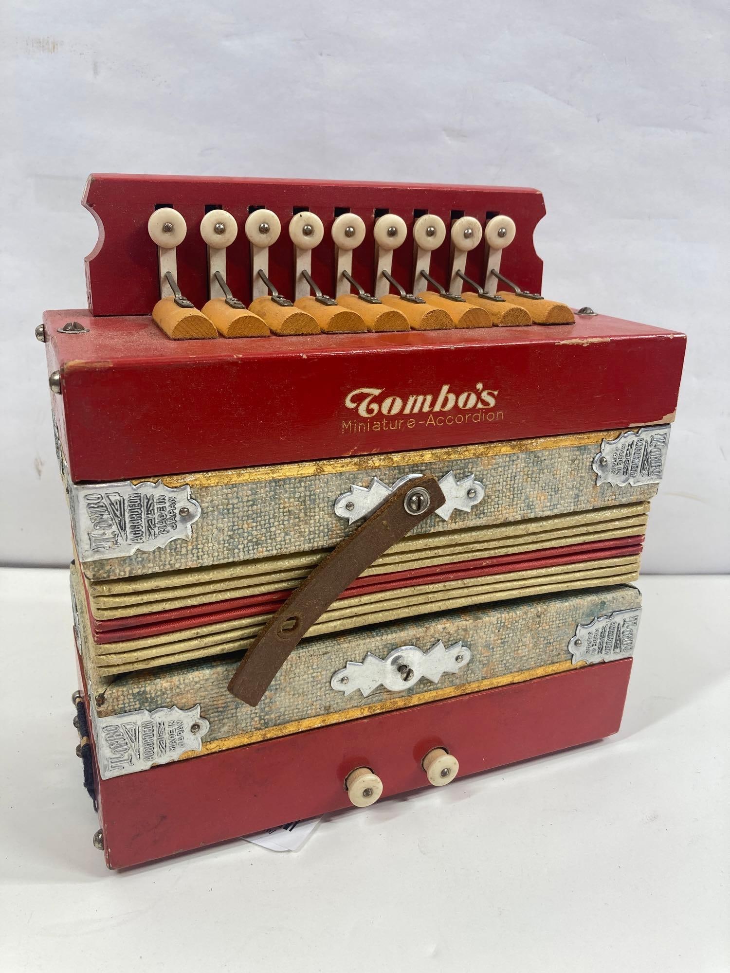 TOMBOS MINIATURE ACCORDION: MADE IN JAPAN, HAS PRESSURE AND SOUNDS GREAT. APPROX 8X7X4 WHEN CLOSED
