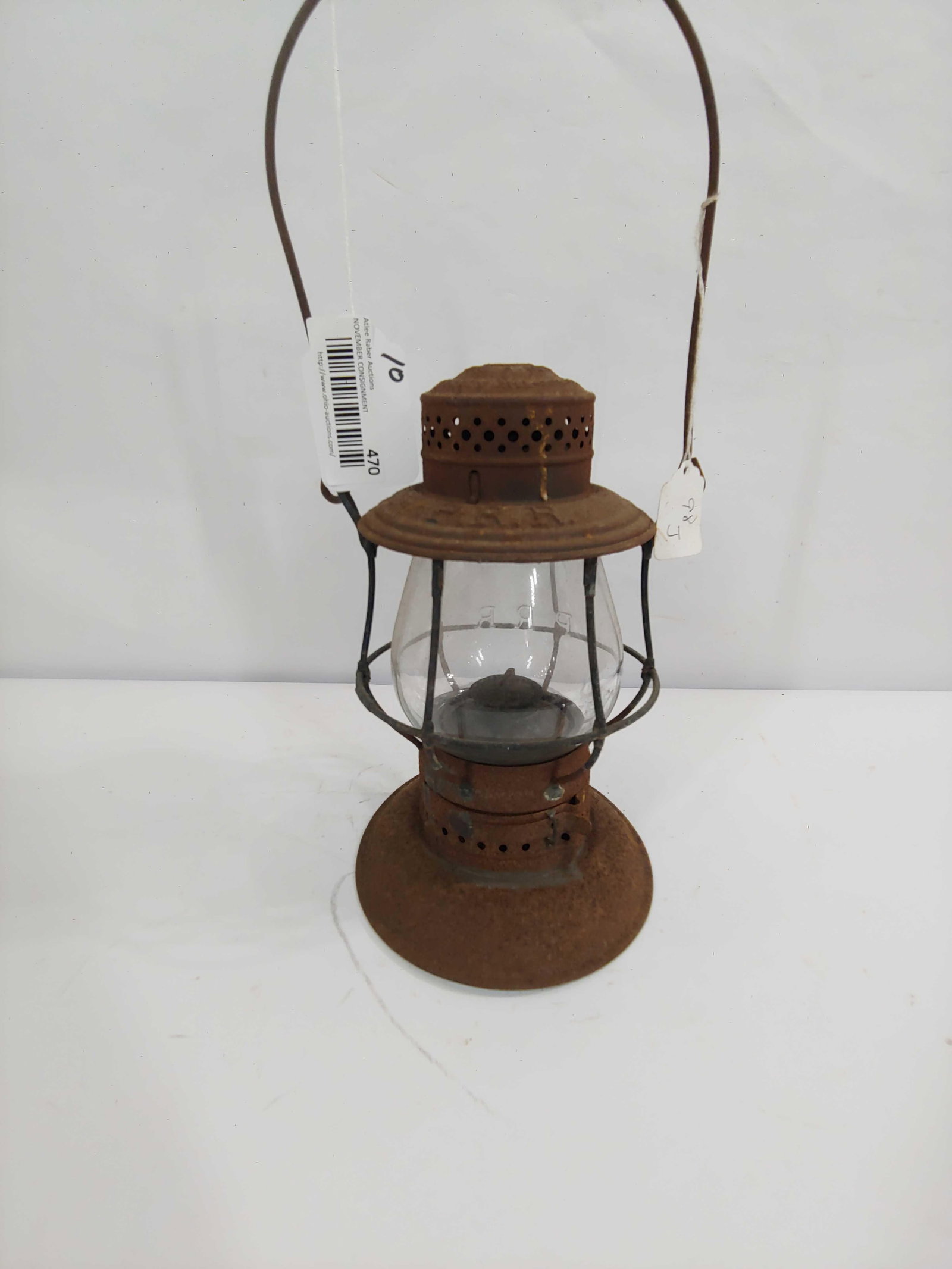 PRR RR LANTERN: MATCHING EMBOSSED GLOBE AND BODY. THE ADAMS AND WESTLAKE COMPANY. BODY SHOWS RUSTING AND A BEND TO LOWER BASE. APPROX 10 INCHES TALL