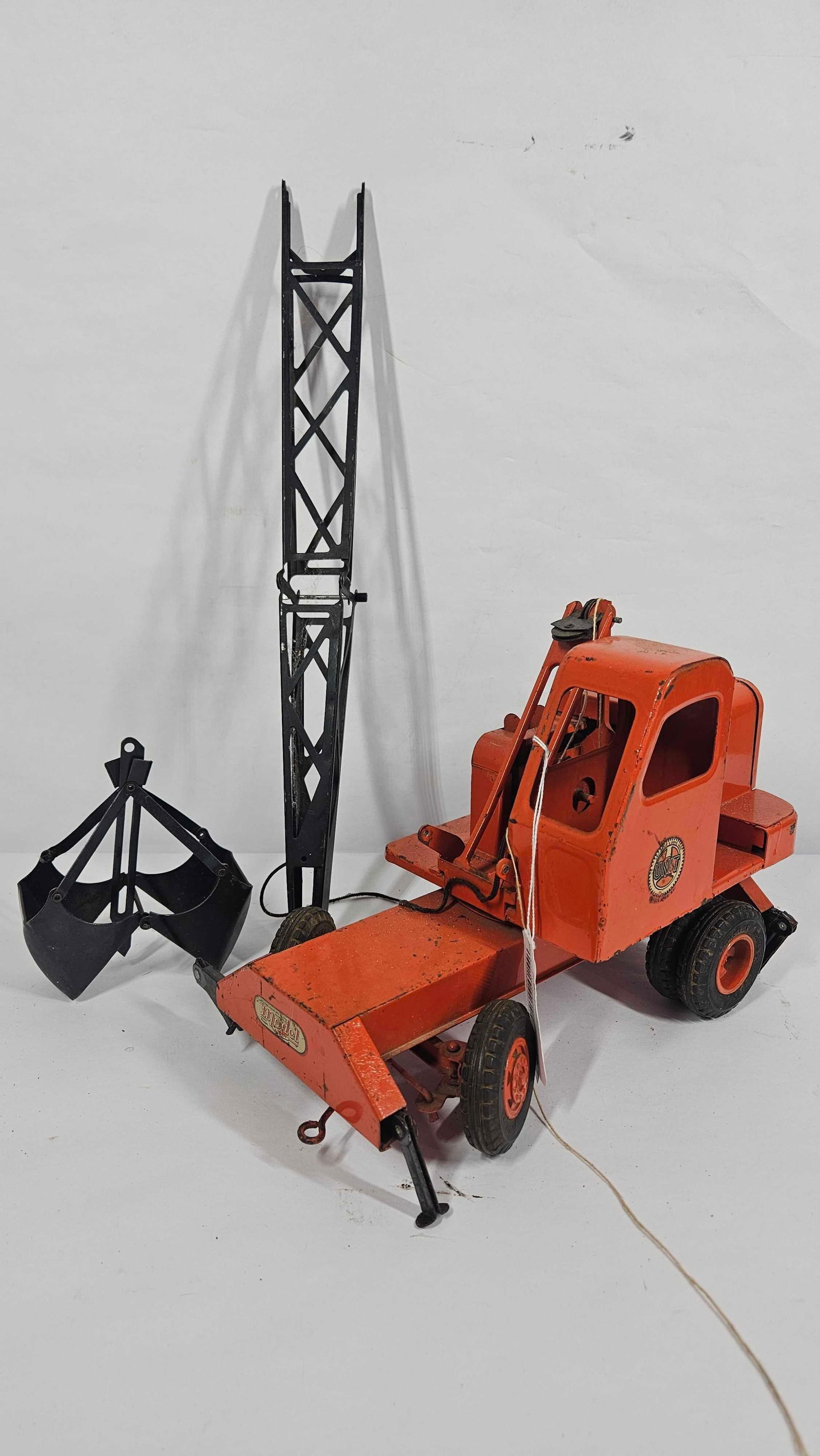DOEPKE UNIT CRANE AND SHOVEL VEHICLE: ALL PARTS ARE PRESENT BUT SCREWS HAVE COME LOOSE FROM CRANE. APPROX 30 INCHES LONG WHEN ASSEMBLED. SOME MINOR PAINT LOSS ALONG EDGES