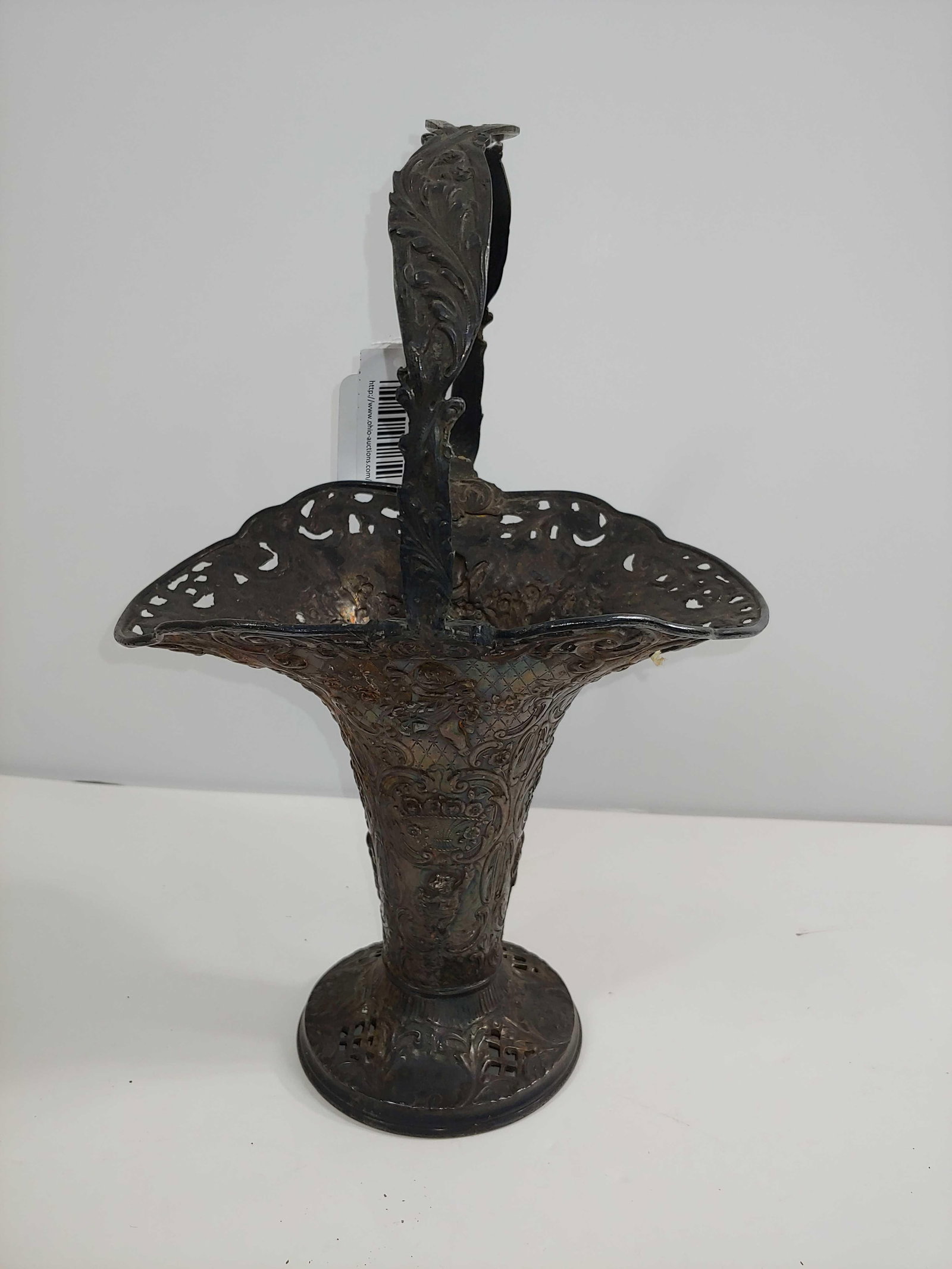 1800S SILVER PLATED BRIDAL VASE: DECORATED HEAVILY WITH CHERUBS AND FLORAL DESIGN. APPROX 12 IN TALL. MONOGRAM TO TOP OF HANDLE.