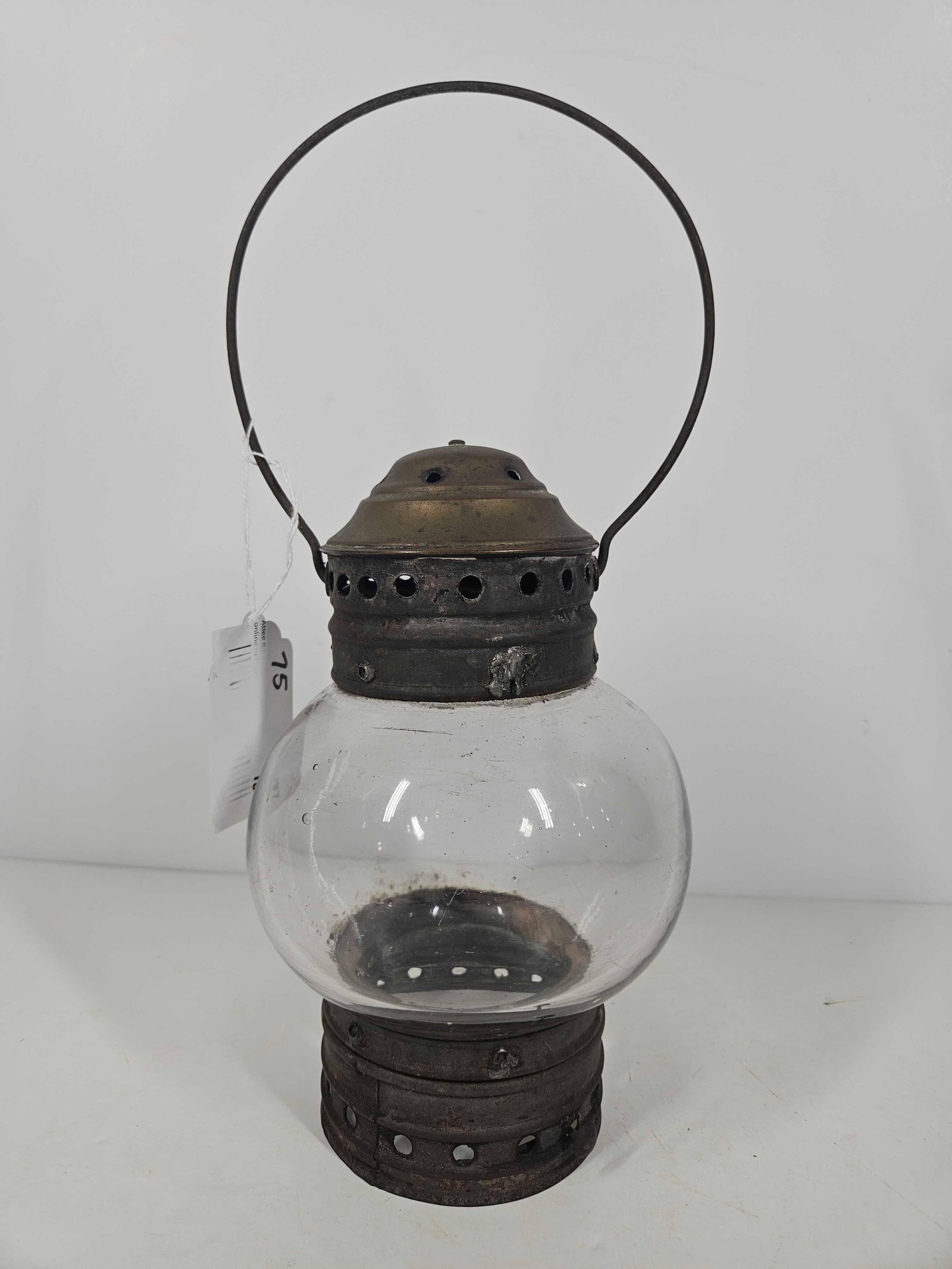 BUBBLE GLASS BRASS LANTERN: BURNER IS NOT PRESENT. 9 INCHES TALL X APPROX 5. GLASS GLOBE APPEARS TO BE HAND BLOWN