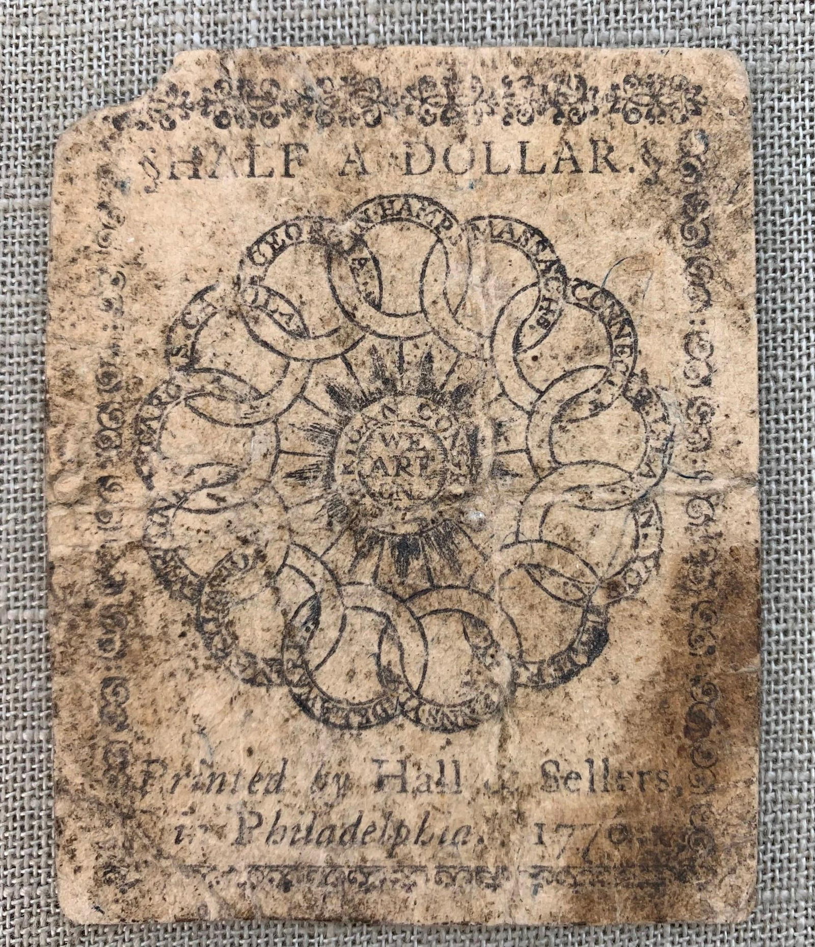 1776 Colonial 1/2 Dollar Hall & Sellers Printed Paper Money Bill: Philadelphia, Nip to one corner, printing is legible, folds and creasing to the paper, EARLY 1776 currency.