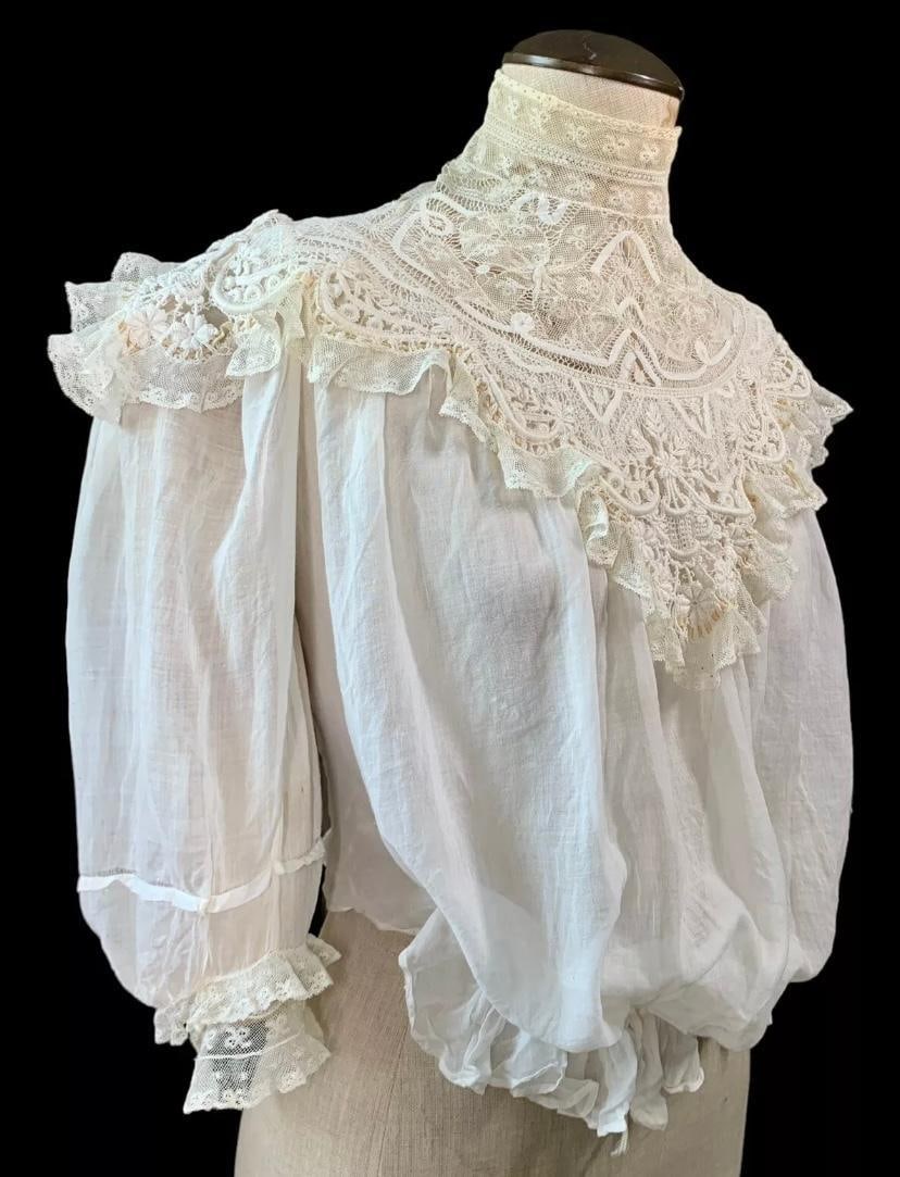 Edwardian 1905 Needle Lace, French Knot, Trapunto Pouter Pigeon Bridal Bodice: Super fine cotton fabric, age and wear to areas of the lace, bracelet length sleeves rear button closure.Bust: 36"Waist: 28"Sleeves: 17"Neck: 13"Length from nape: 18"