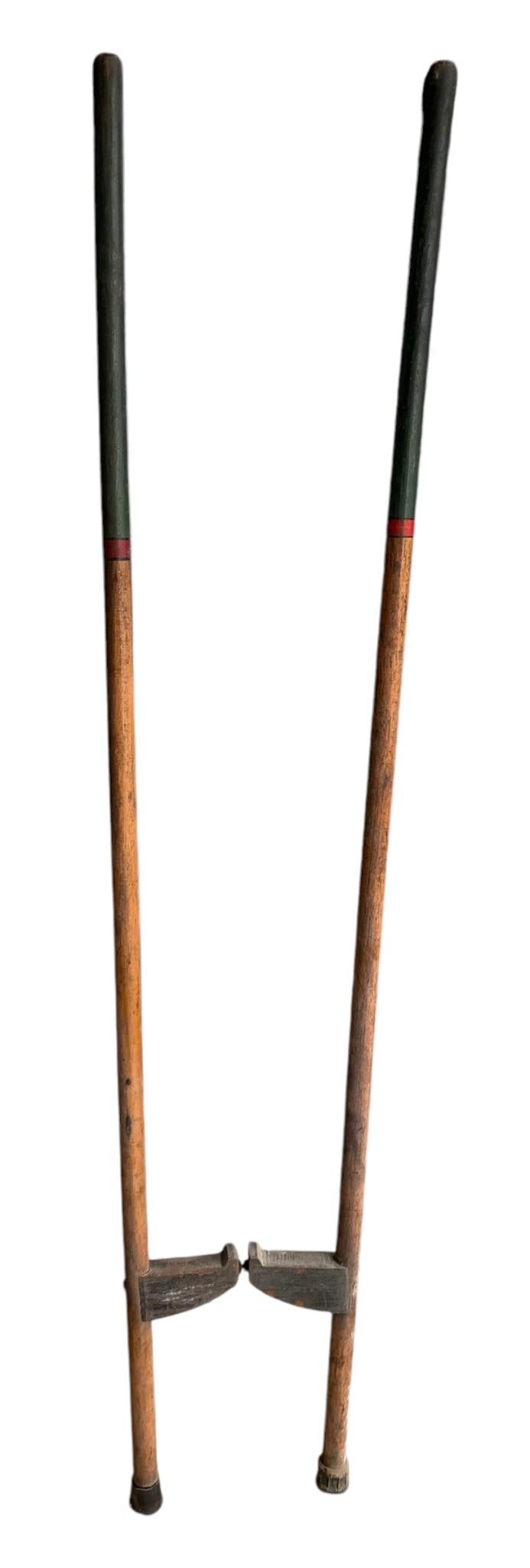61" Early Pair of Carnival, Circus, Wooden Clown Stilts: 61" tall, hand painted trim, adjustable wooden footrest from 12" height to 24".