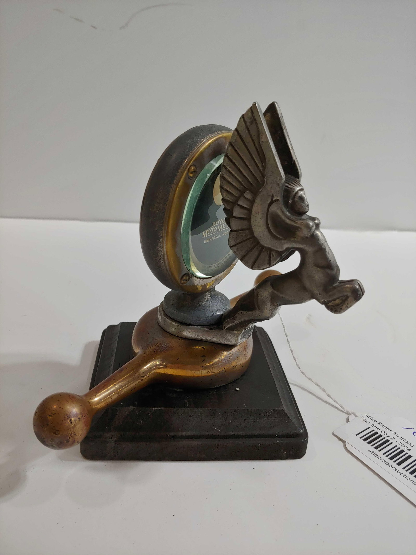 Boyce Moto Meter with Dog Bone cap and Centaur Ornament: Shows some wear but overall In good original condition!! Sets on wooden base.