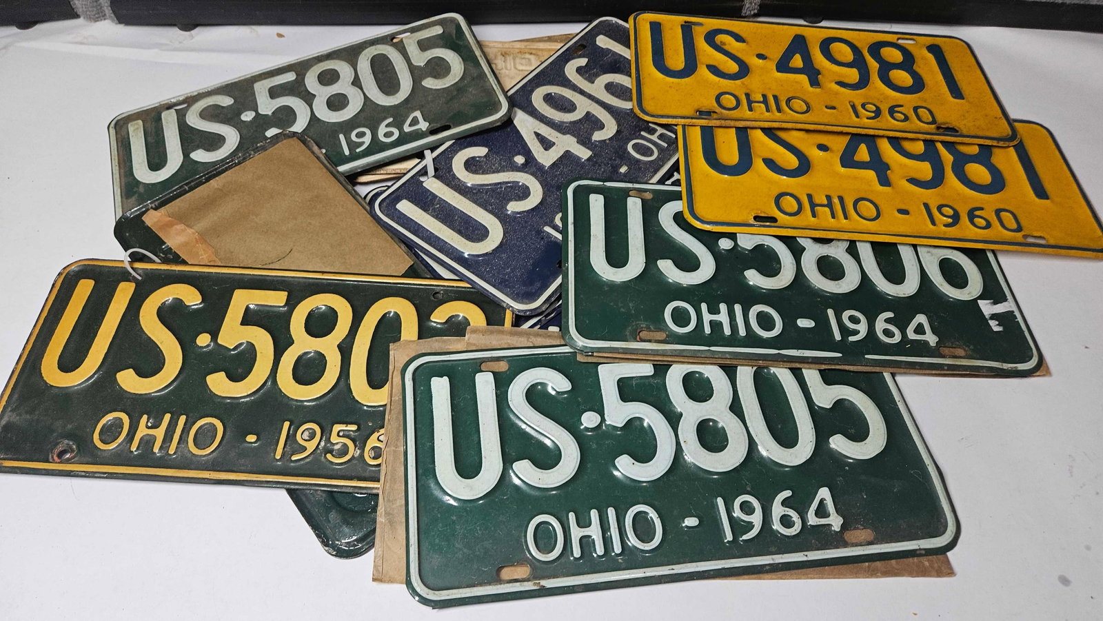 1956-1968 OHIO LICENSE PLATES: MANY MATCH PAIRS, SEVERAL HAVE NEVER BEEN USED AND CONTAIN PAPER SLEEVES