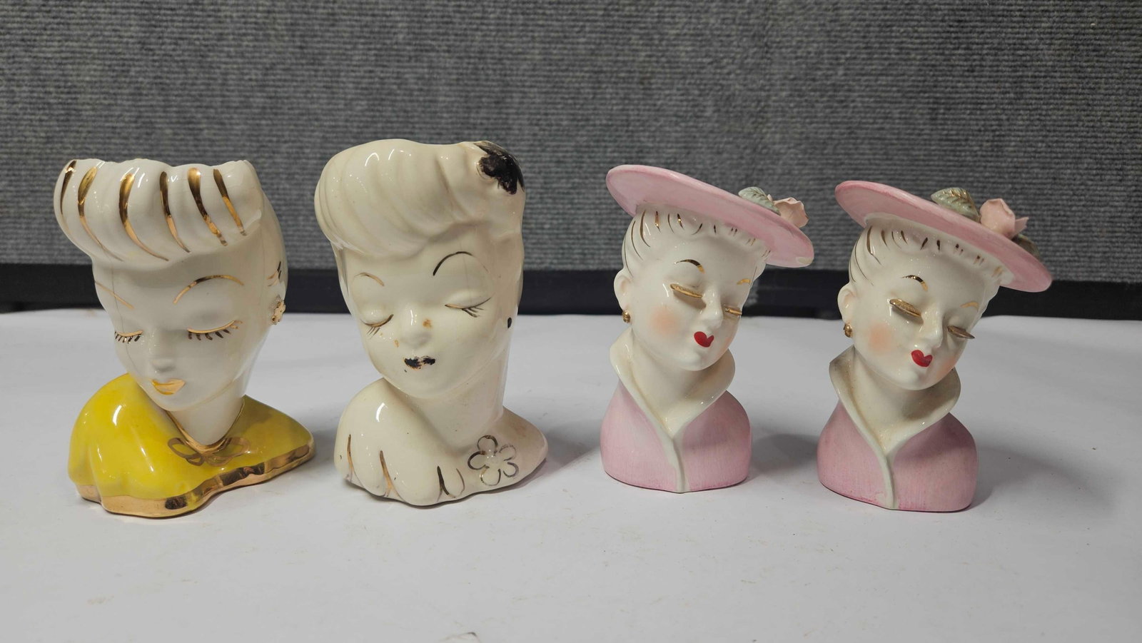 VINTAGE LADIES HEAD VASES: LOT OF 4, SOME MINOR CHIPS MAY SHOW BUT NO MAJOR DAMAGE. EACH IS APPROX 4.5 INCHES TALL
