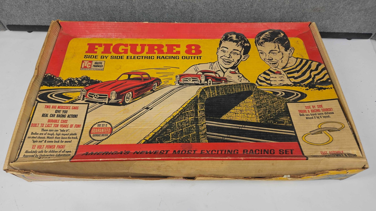 FIGURE 8 SIDE BY SIDE ELECTRIC RACE TRACK: CARS, TRANSFORMER AND SOME TRACK ARE INCLUDED, UNSURE IF THIS IS COMPLETE. PLEASE SEE PHOTOS.