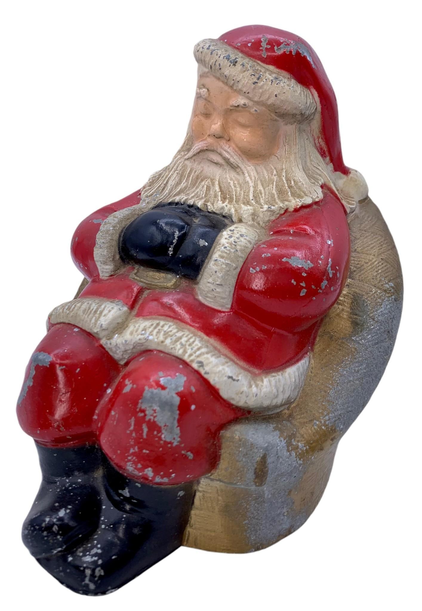 1950s People's Federal Savings Bank Cast Metal Sleeping Santa Coin Bank: 6 3/4" x 6" x 5 1/2", a few coins jingling around inside, some paint loss to the metal, Banthrop Chicago visible on the base, solidly constructed.