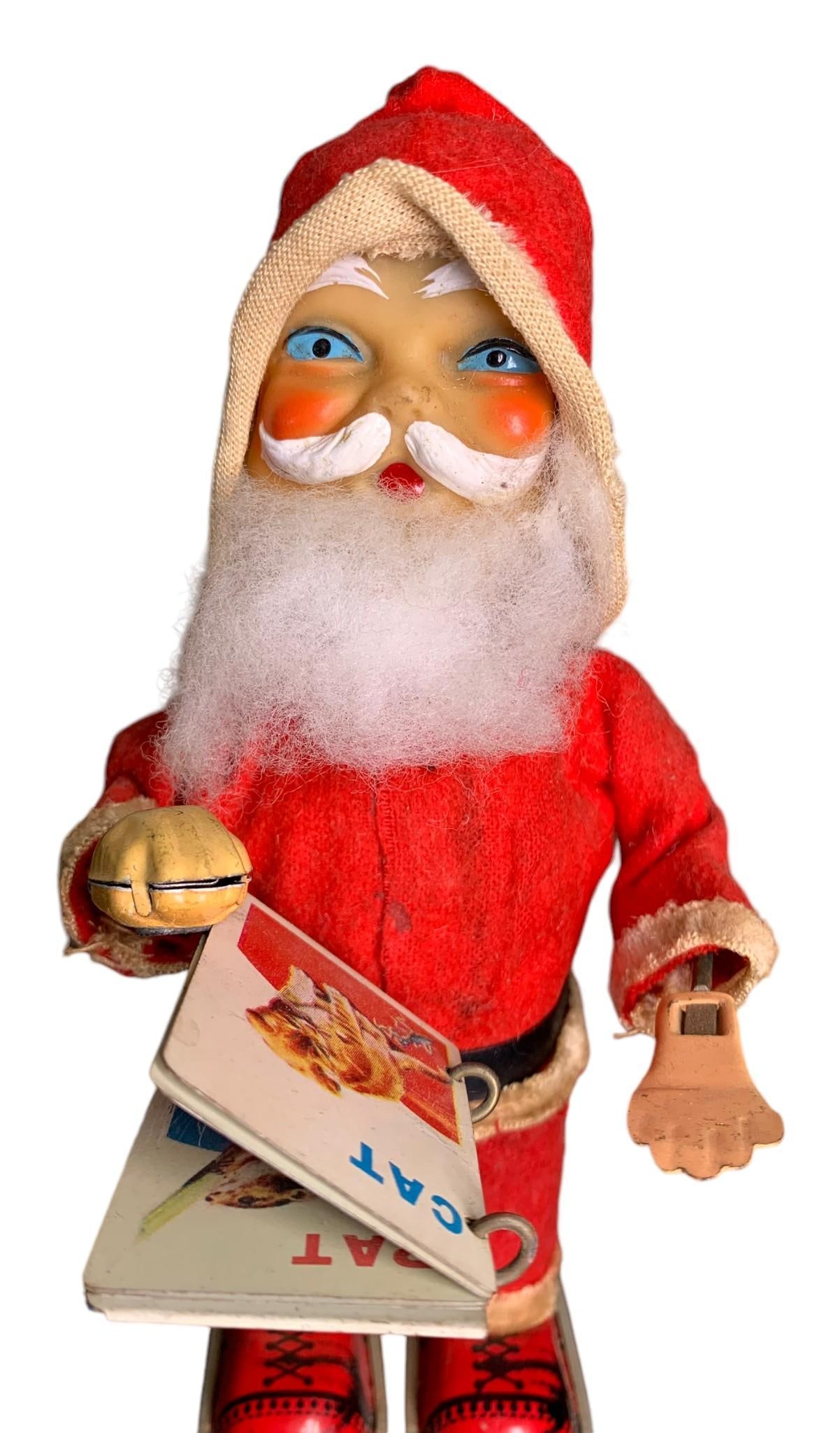 Working Wind Up Made in Japan Mechanical Magnetic Hand Reading Tin Litho Santa Toy: 7 1/2" x 4" x 5", works when wound, some age and wear to the materials.