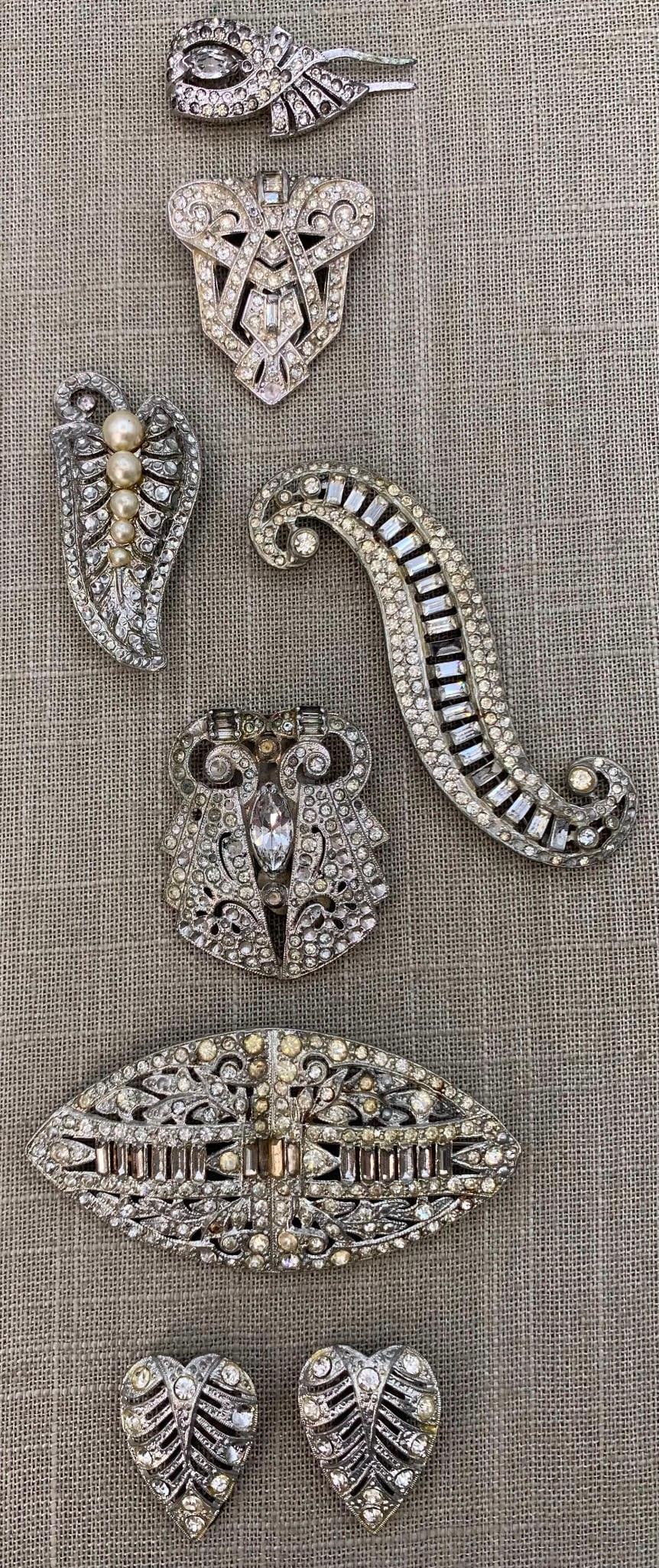 8 pc Art Deco Rhinestone Dress, Millinery, Fur, Shoe Clips & Brooches: Luxe assortment, loads of sparkle, some missing stones, working closures, 1 1/4'' to 3 3/4".