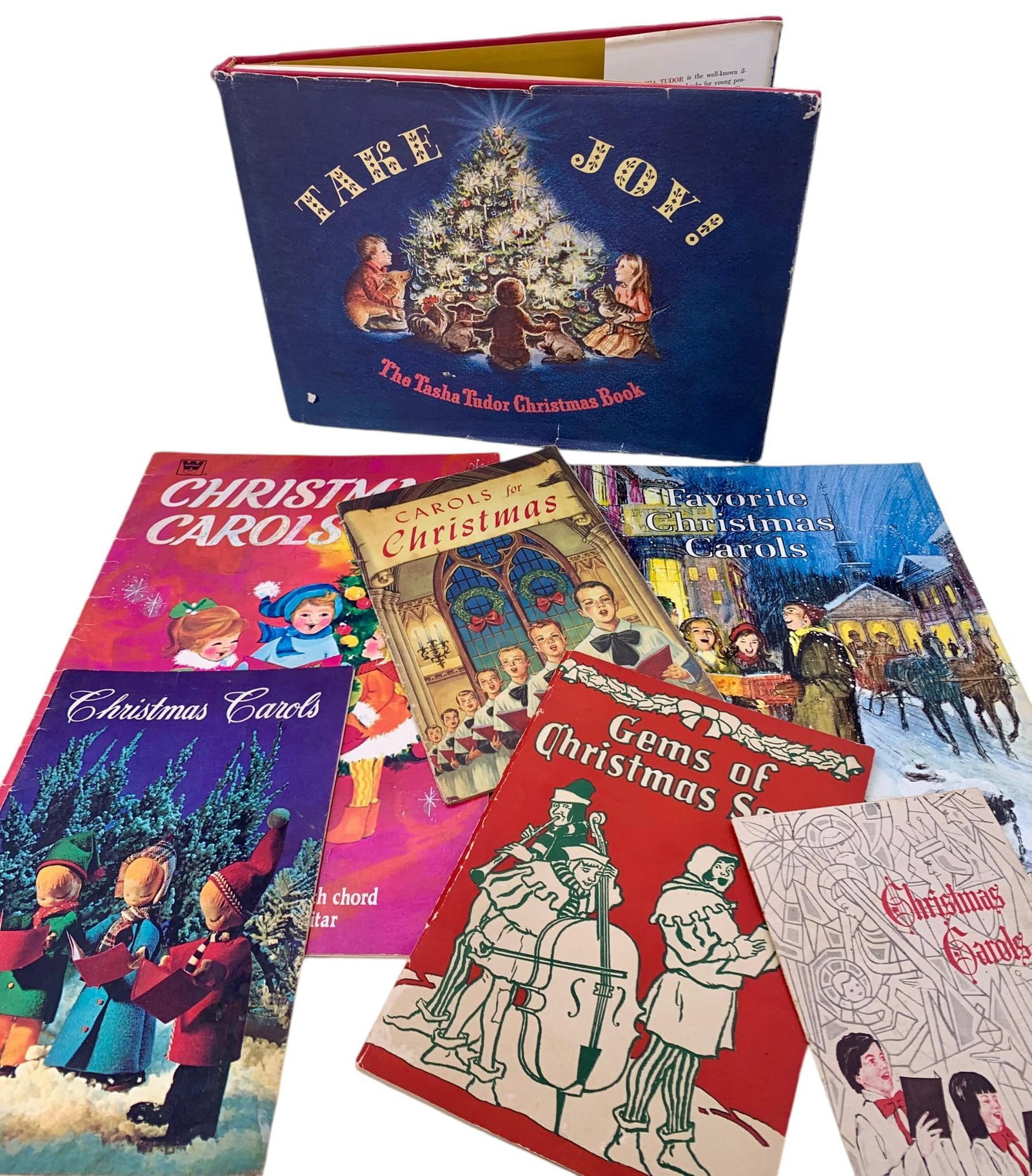 6 Vintage Christmas Carol Song Books & The Tasha Tudor Christmas Book: 1950s to 1970s era books, each with some age and wear, vibrantly hued and illustrated.