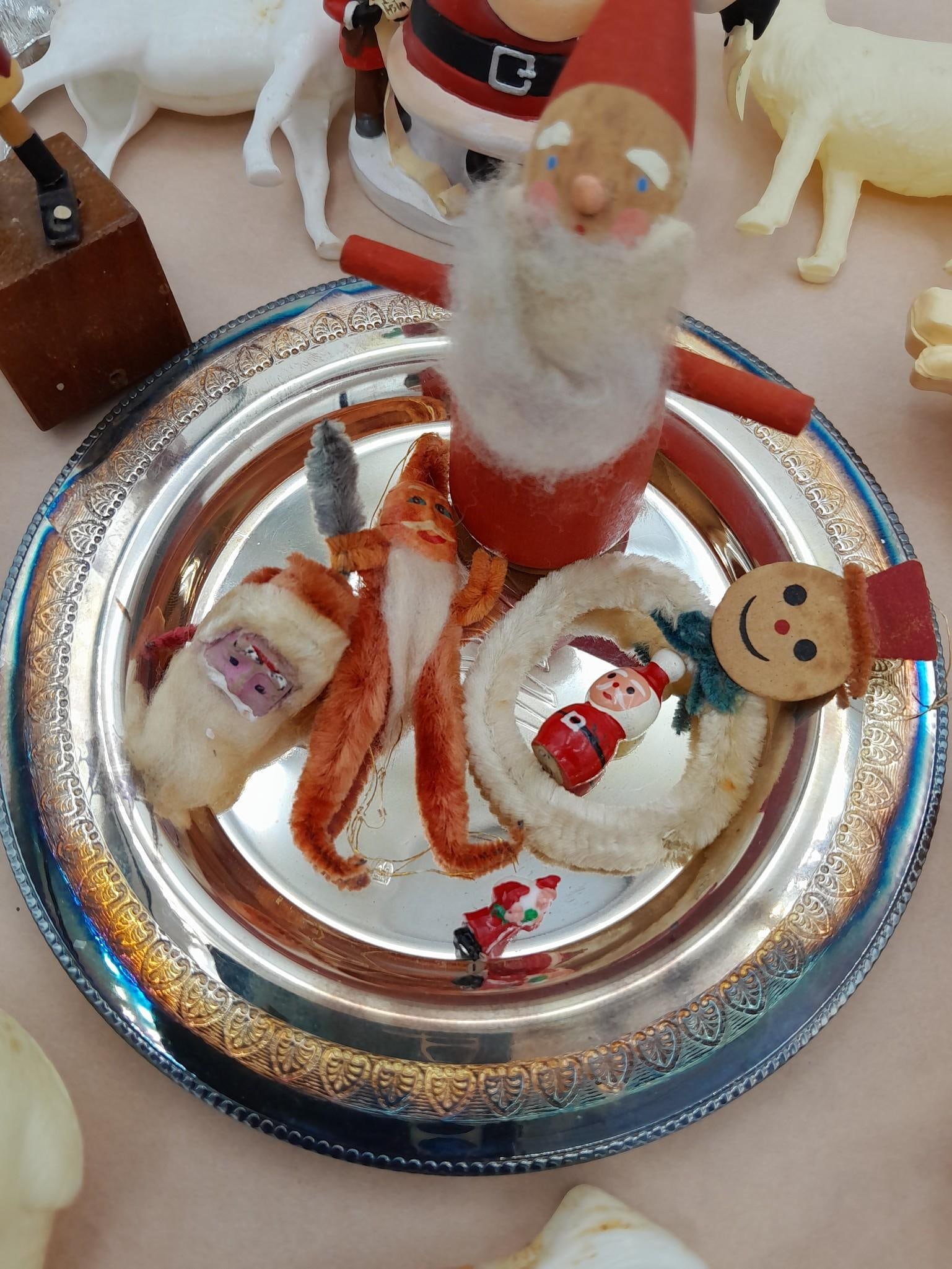 40 pc Antique to Vintage Christmas Decorations & Holiday Photographs: Miniature Santas, celluloid and hard plastic reindeer, Victorian era to 1950s Christmas photos, silverplate tree plate with felt storage sleeve, early character glass light bulbs and more.