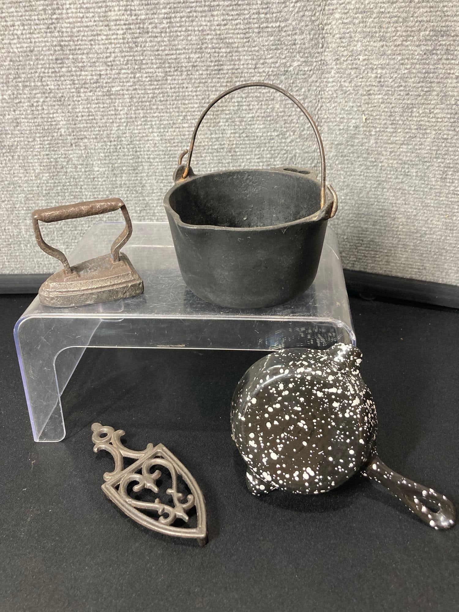 3pc cast iron lot: Includes a Wagner melting pot, 4in diameter, Wagner porcelain covered skillet ashtray and Miniature sad iron with trivet.