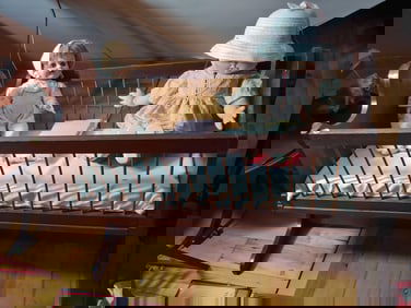 Early baby cradle with dolls