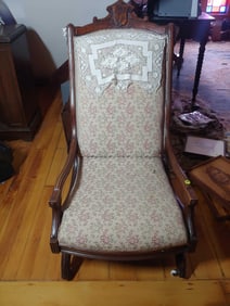 Antique Victorian upholstered rocker on casters