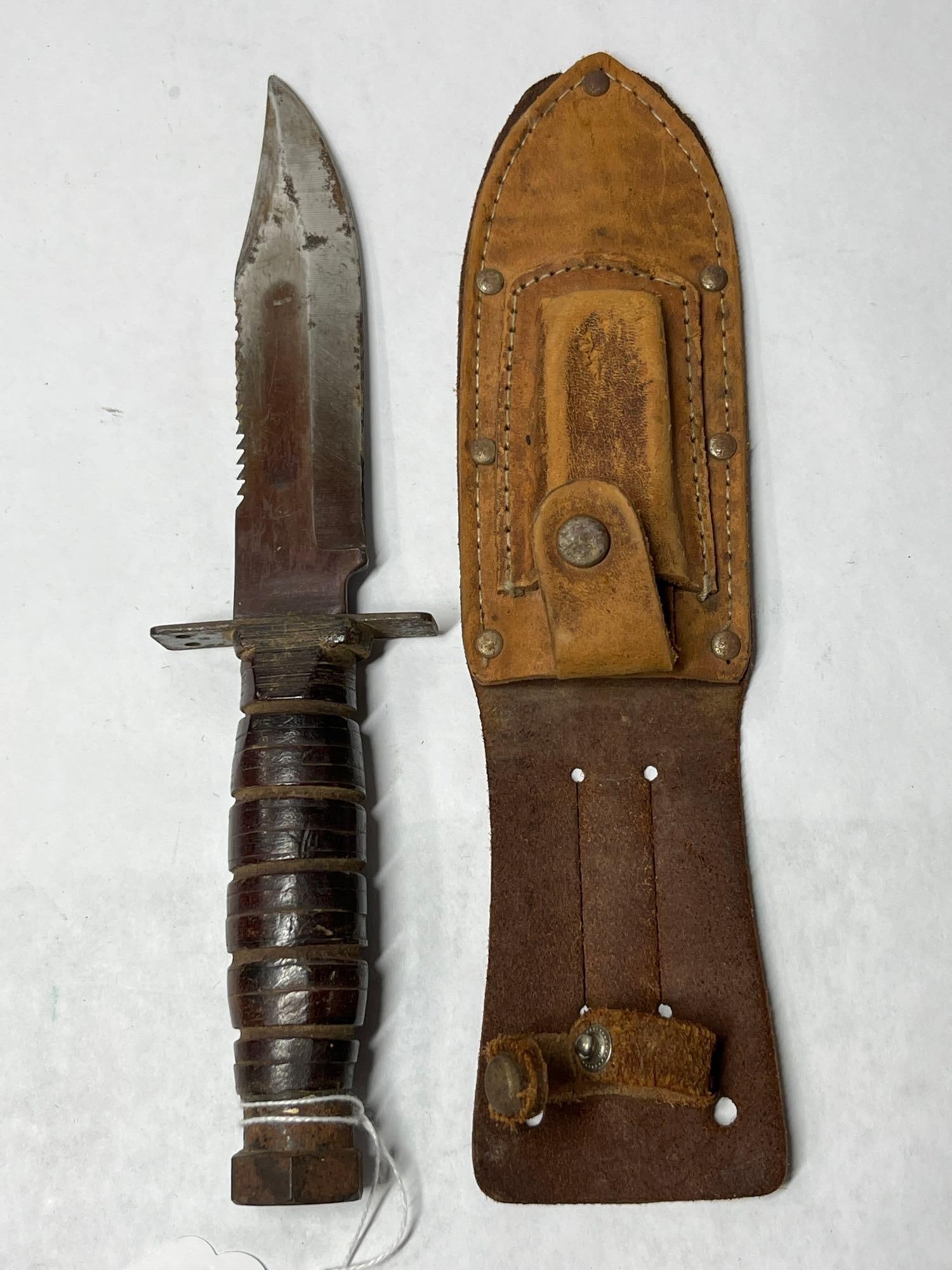 Vietnam War Military Survival Knife: 5 inch blade with wood handle and leather belt pouch.