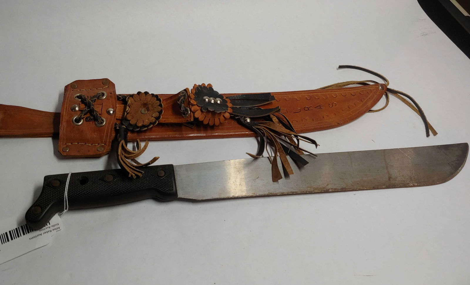 Honduras Long Blade Machete: 14 inch blade with plastic handle and leather decorated sheath.