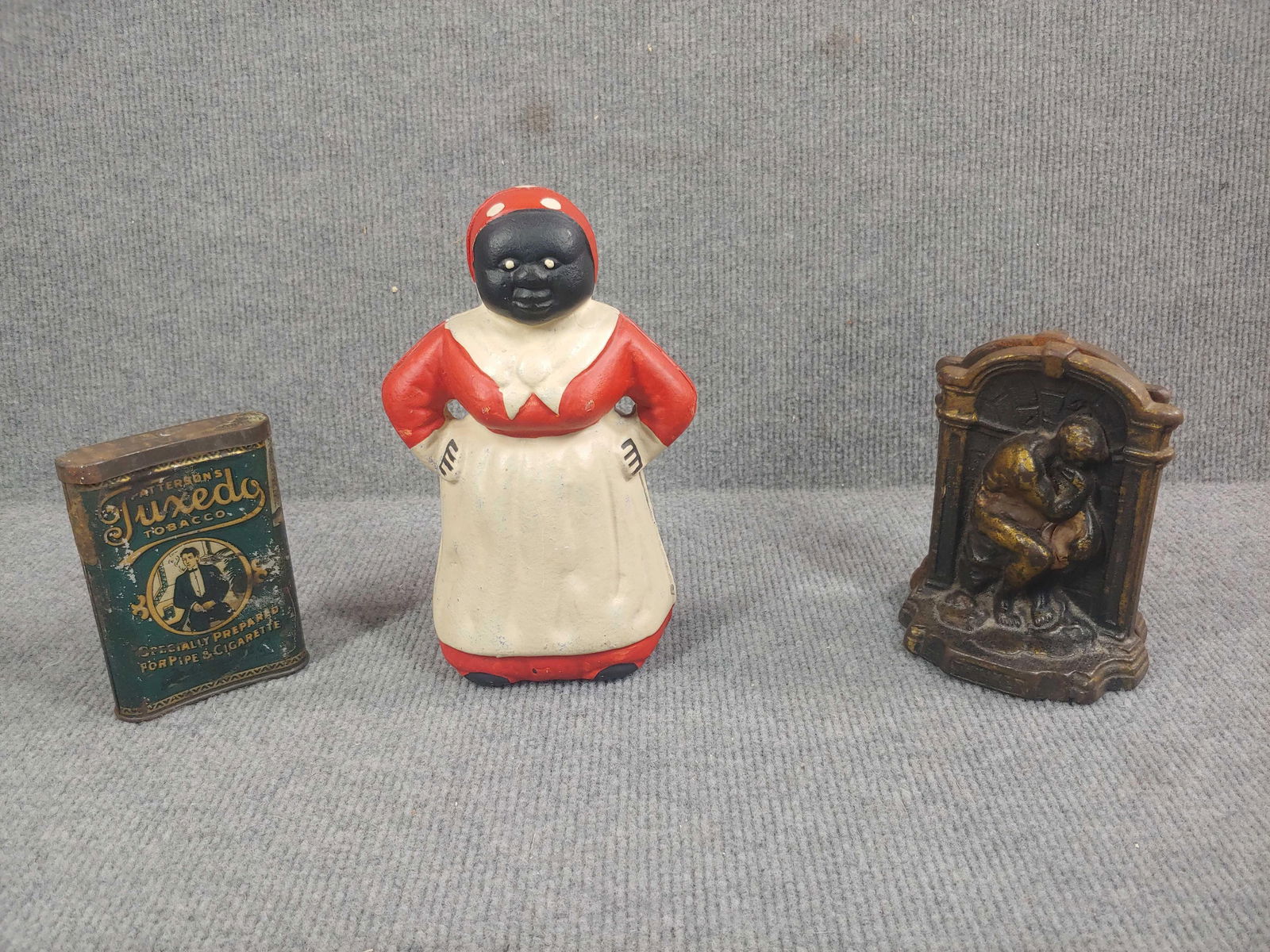 Cast Iron Mammy Bank, Tobacco Tin, and Thinker Bookends: Cast iron bank is newer, 8 inches tall
