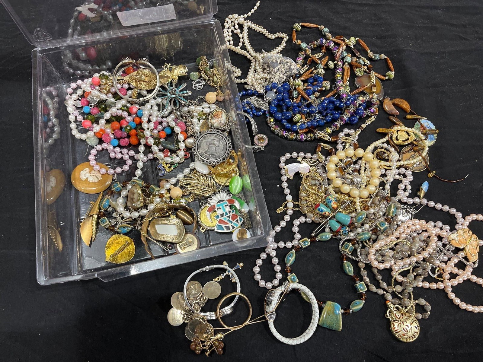 Pearls, Necklaces, and Costume Jewelry: Brooches, stone jewelry, necklaces and more. This lot has not been thoroughly checked out and most likely contains treasures such and gold, or sterling silver!