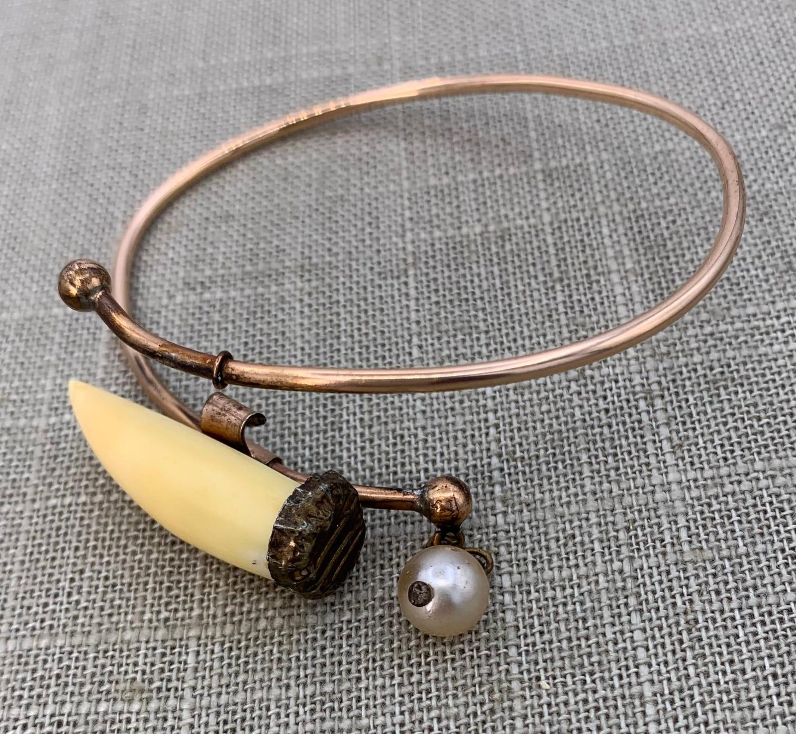 Unusual Victorian era Composite Tooth, Faux Pearl, Gold Filled Bangle Bracelet: Partial embossed stamping on the metal cap covering the end of the composite tooth, glass "Pearl" gem drop, working closure, 6 7/8" interior wrist circumference, light distortion to the metal from use