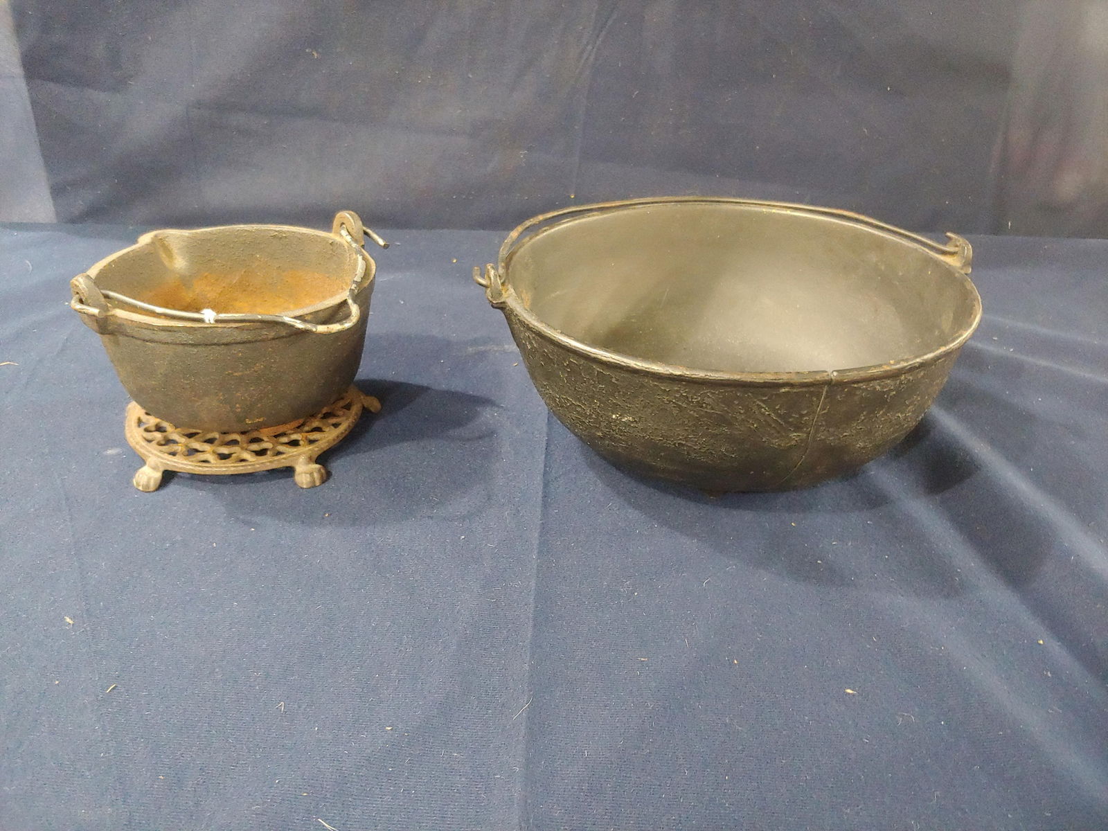 Cast Iron Melting Pot, Candy Pot and Trivet: Larger 10 inch pot has several cracks. small is 5.5 inches.