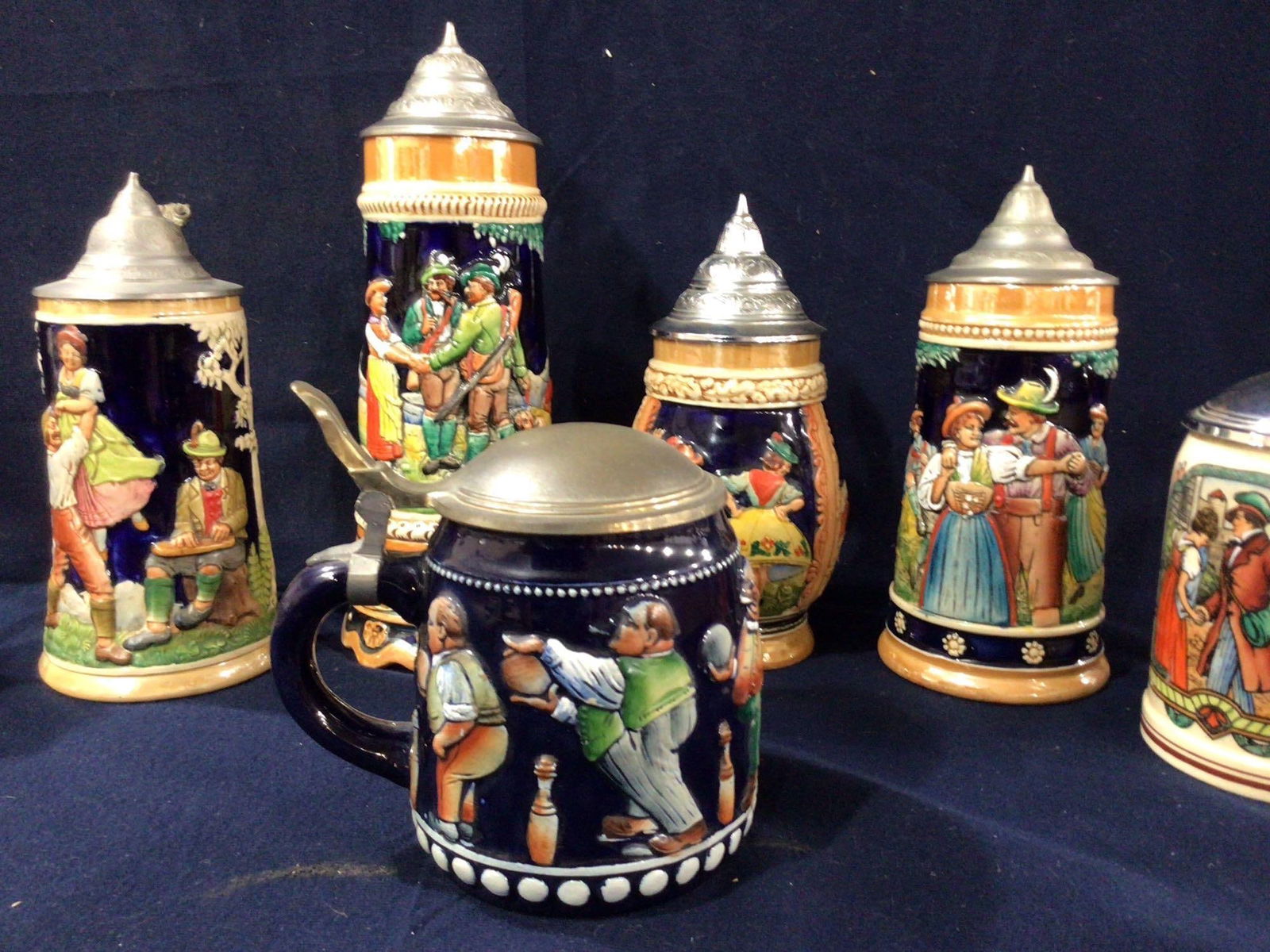 German Antique Steins: 7 steins each with great images. One is a music box.