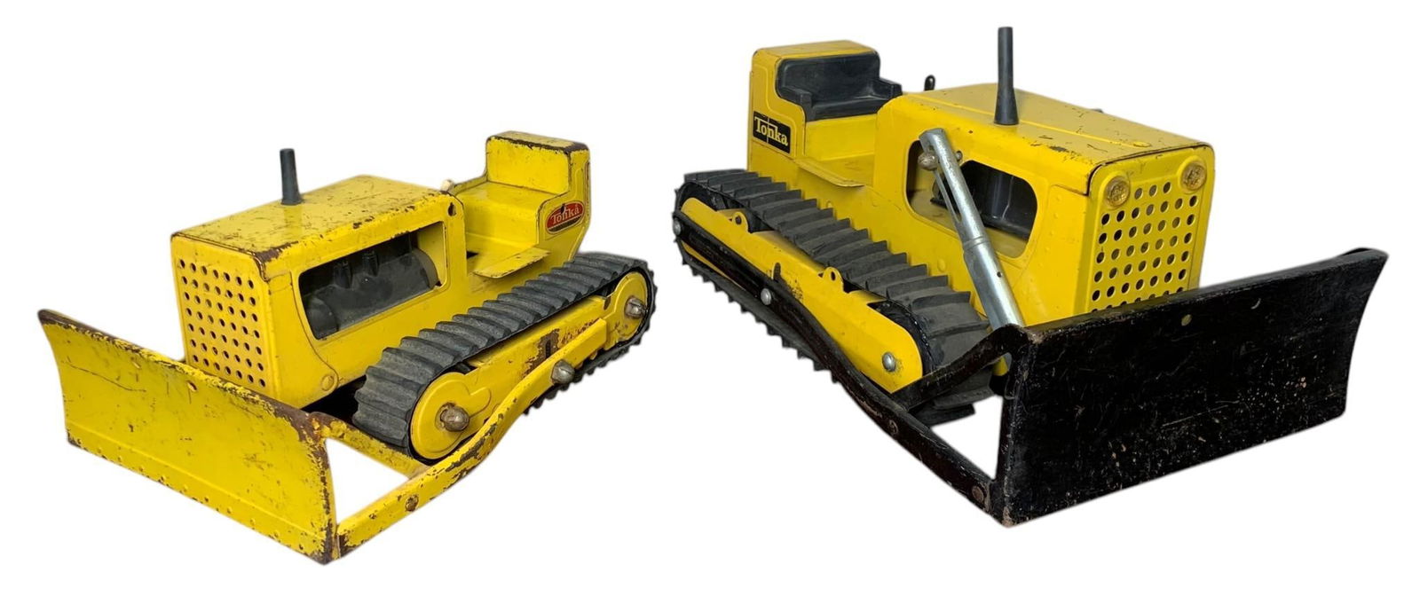 2 Vintage TONKA Bulldozer Construction Vehicle Toys: Lot of 2, one 12" x 7 5/8", the other 9" x 6", rubber tracks, Tonka decals, a small pin is absent on one arm of the blade on the 12" dozer as shown.