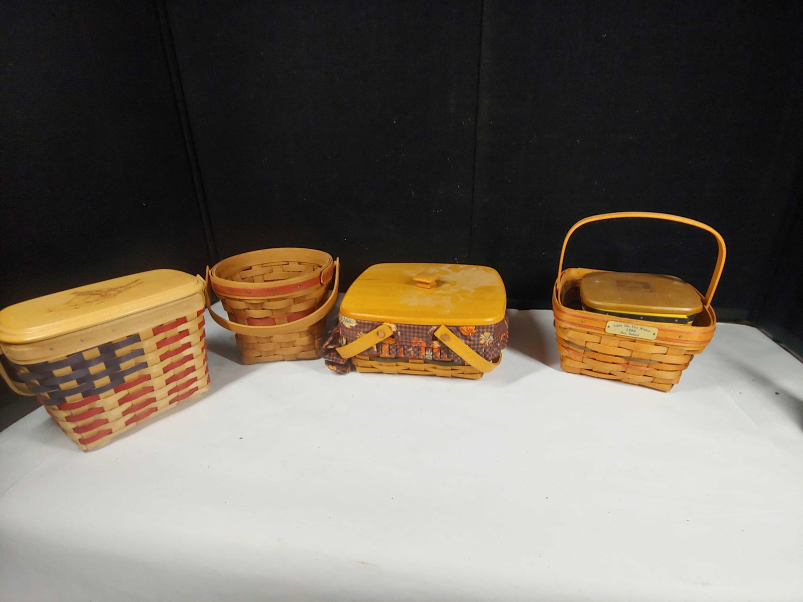 Longenberger Army, Americana, and Harvest Baskets: 5- various size baskets. Including 1988 edition Poinsettia basket, Army strong, Harvest basket w/ liner, 1996 Light the Fire Within Bee basket and more. Dated 1988-2010