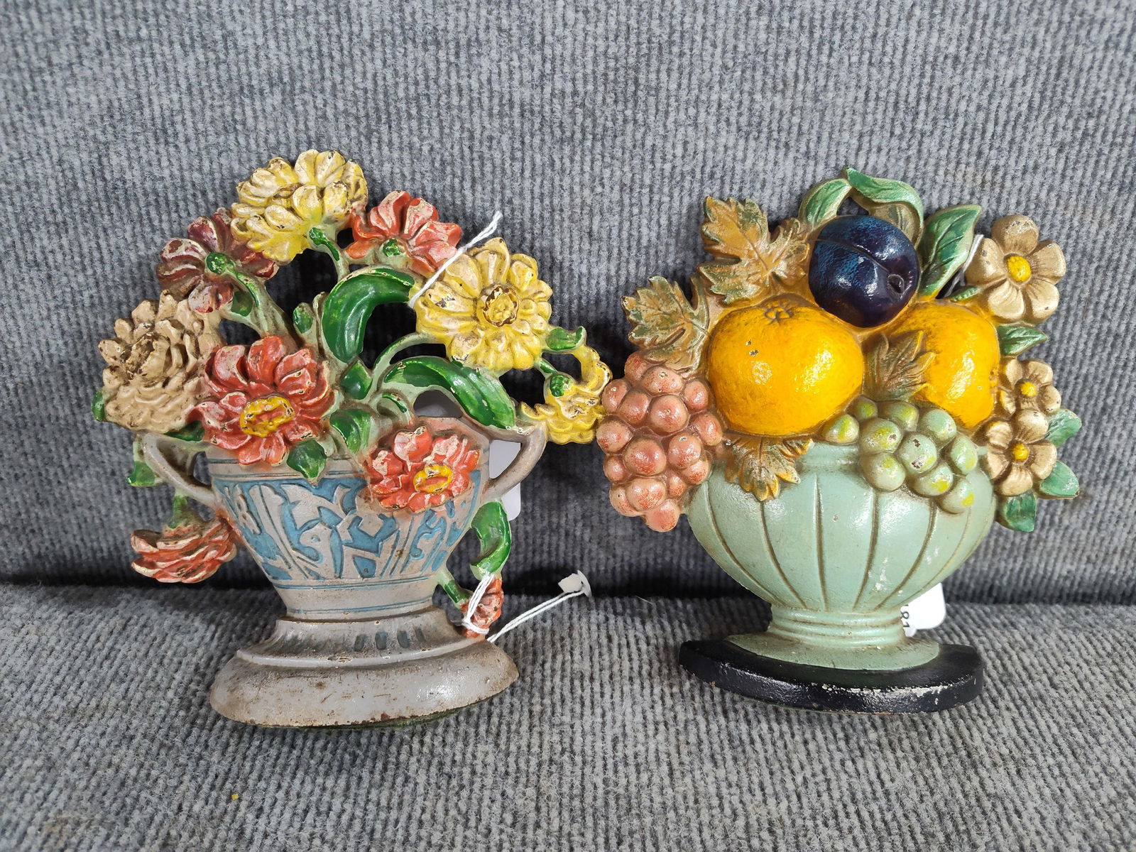 Pair of Hubley Doorstops: Zinnias and fruit bowl. Both with great color. Each is approx 7 inches tall