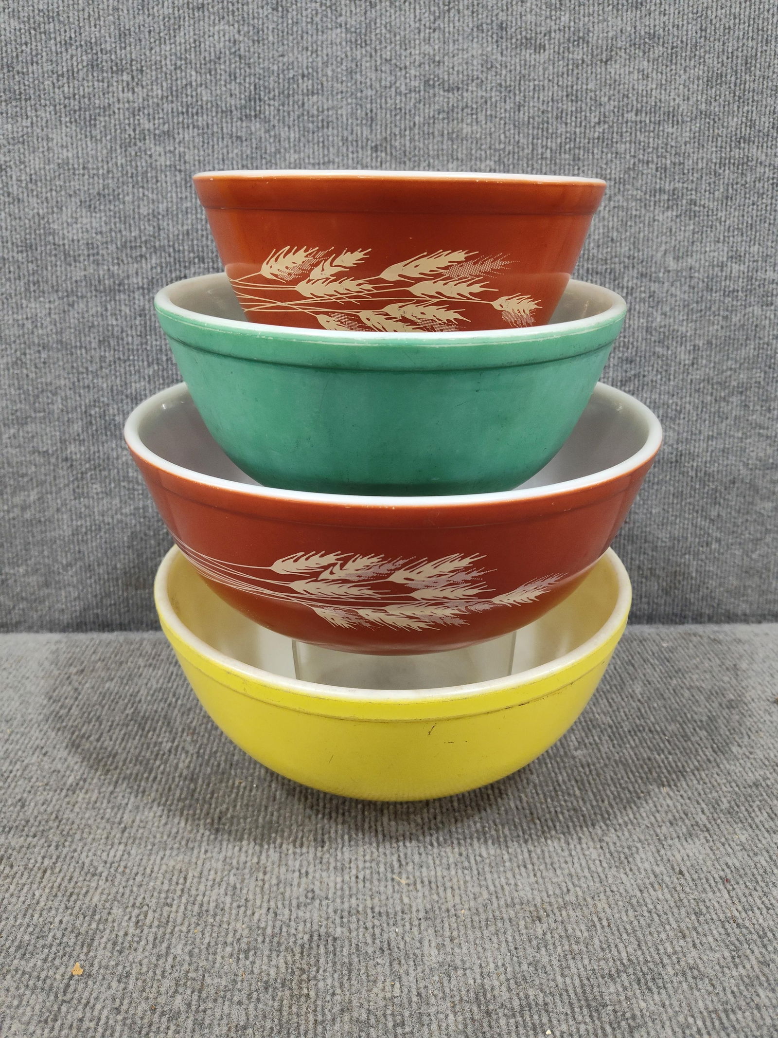 Autumn Harvest, Yellow, and Green Pyrex Mixing Bowls: Yellow and green show some fading and scuffs due to usage. All are free of chips and cracks.