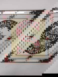 Singer Sewing Machine Stained Glass Window: Painted glass featuring logo and reverse painted lettering. A few areas of chipping paint. 17.5x16