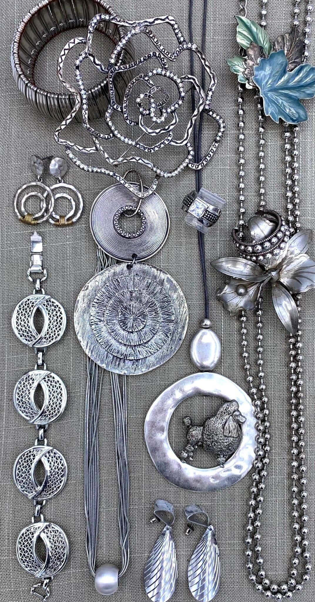 Bold 17 pc Vintage Mid Century to 90s Silver Costume Jewelry Collection: Super fun assortment with working clasps, some missing rhinestones on the 4" rose brooch, etched aluminum, enamel, hammered detail and more!