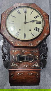 Early Wall Clock with Mother of Pearl Inlay: Tin dial with glass brass framed swing out face cover, octagon dial case is pegged. Includes key and pendulum. Does have a crack on each side of Leaded Glass window. Was not tested if works. Unusual e