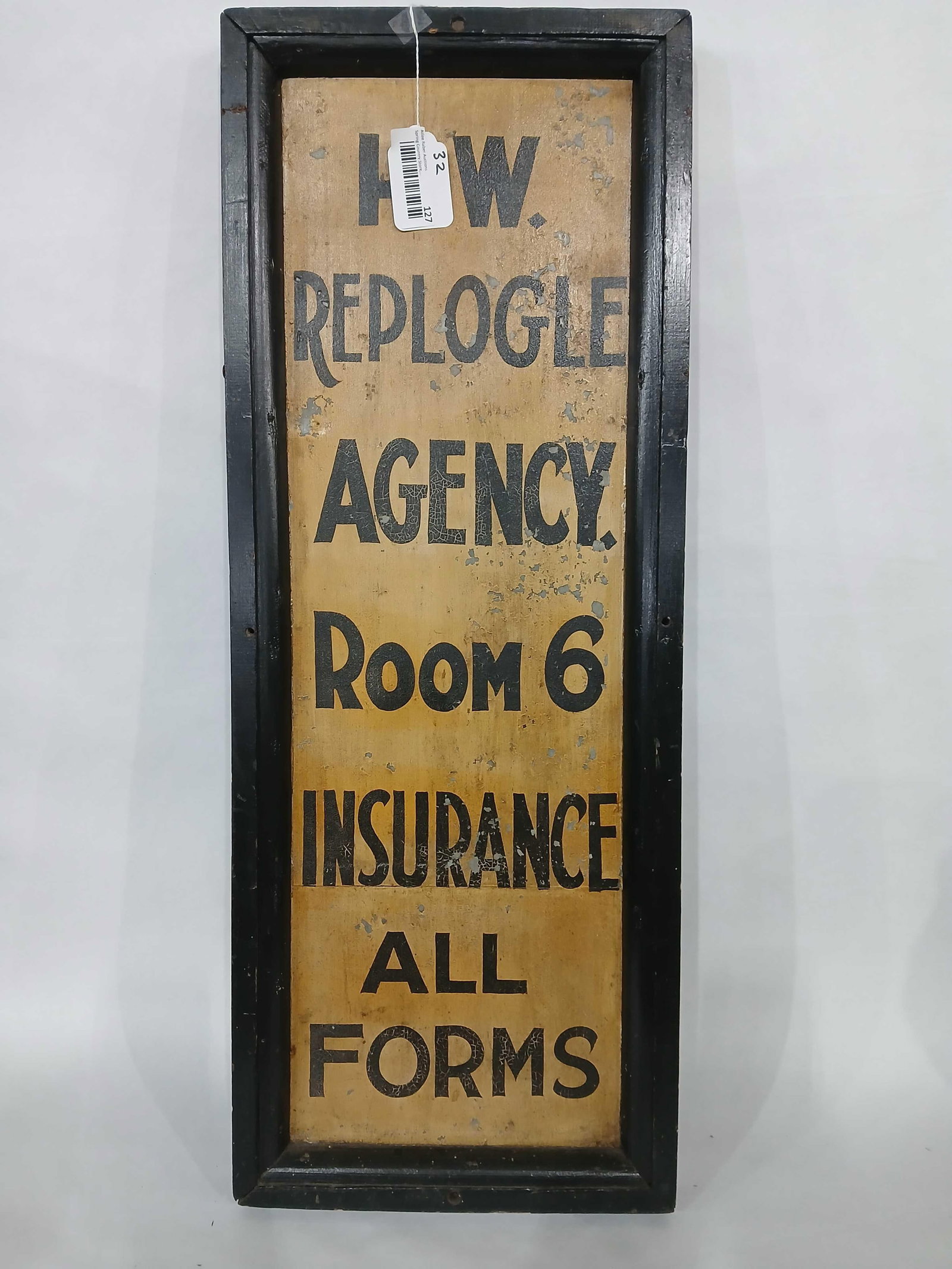 H.W. Replogle Agency wood framed sign: 1-sided painted metal sign in wood frame. Shows peeling in areas but seems to be fairly stable. 13in x 34.5in.