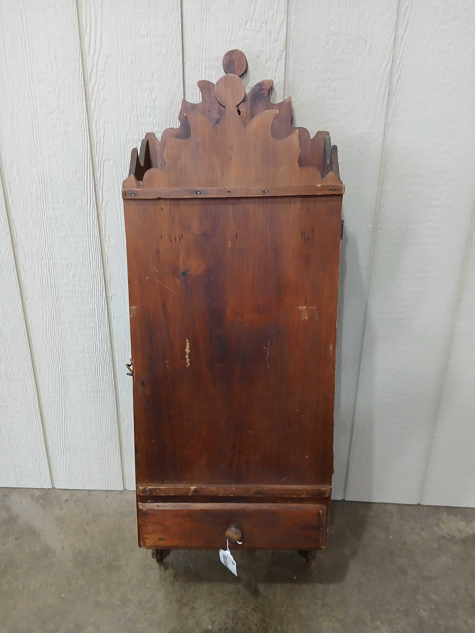 19th Century Carved Apothecary Cabinet: Uniquely carved topper and bottom corners. Interior cubbies may have been added later as Chewing gum crate stenciling shows to one side. One drawer on lower section. 44.5x14.5x8
