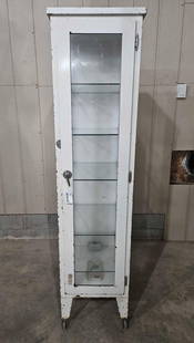 Early Metal Medical cabinet with shelves: Sets on casters. 16in wide 19in deep 68in tall.
