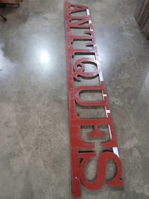Metal cutout ANTIQUES sign