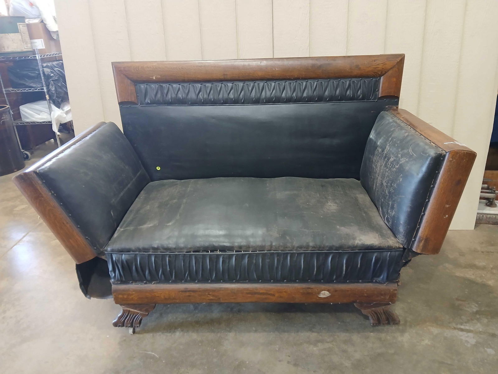 Oak Victorian Leather Chaise Lounge: Each end folds down to extend seating length. Leather shows some wear but is free of tears or rips. Great carved feet. 59x 29x42