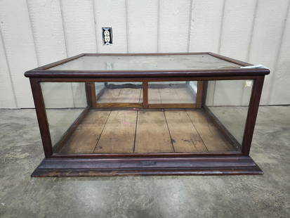 The Sun Mfg Co Country Store showcase: Early oak showcase with 3 glass sides and top. With sliding rear access doors. Is covered in storage dust but will clean up great! 32.5in wide 25.5in deep 16in tall.