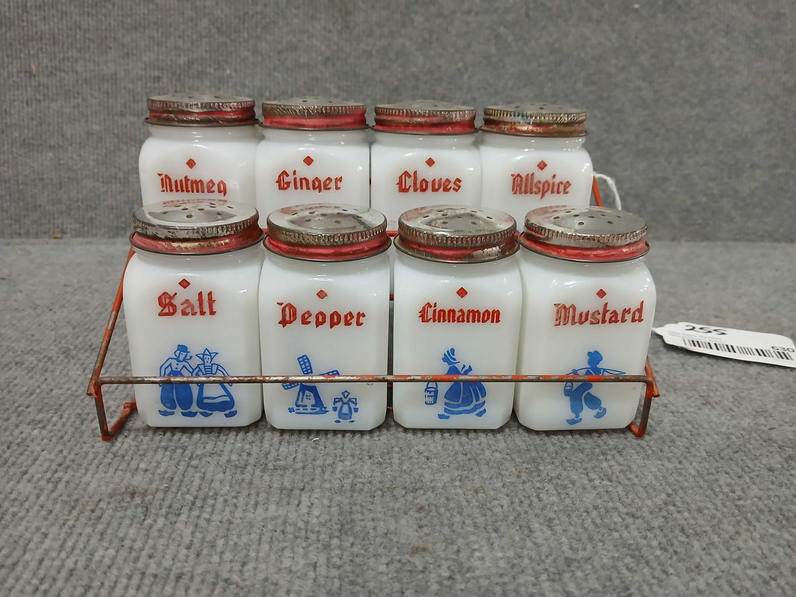 Great 1920s-30s Dutch milk glass spice set: Tops show paint wear but overall are in great used condition! Jars are 3in tall, rack is 8.25in wide 4.5in deep.