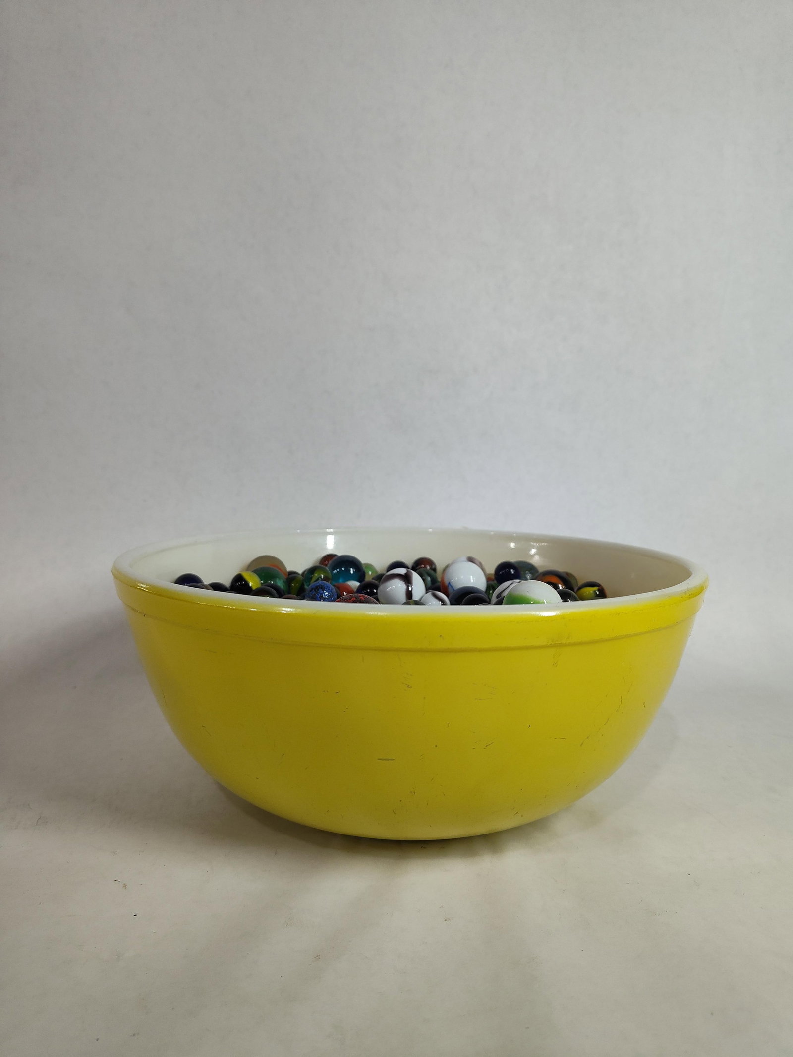Large Pyrex Bowl of Marbles & Shooters: 100s of styles and colors of marbles. Pyrex bowl is in good condition