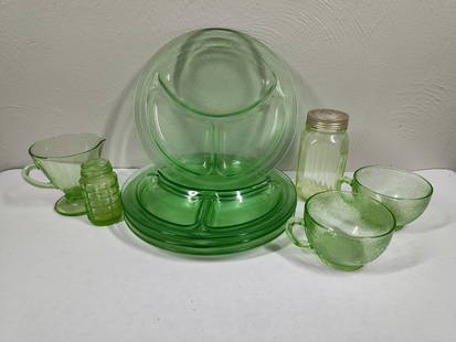 Uranium Glass Plates, Cups, and Shaker: One shaker is missing lid. 4 sectioned plates, two mugs, cup with spout and two shakers.