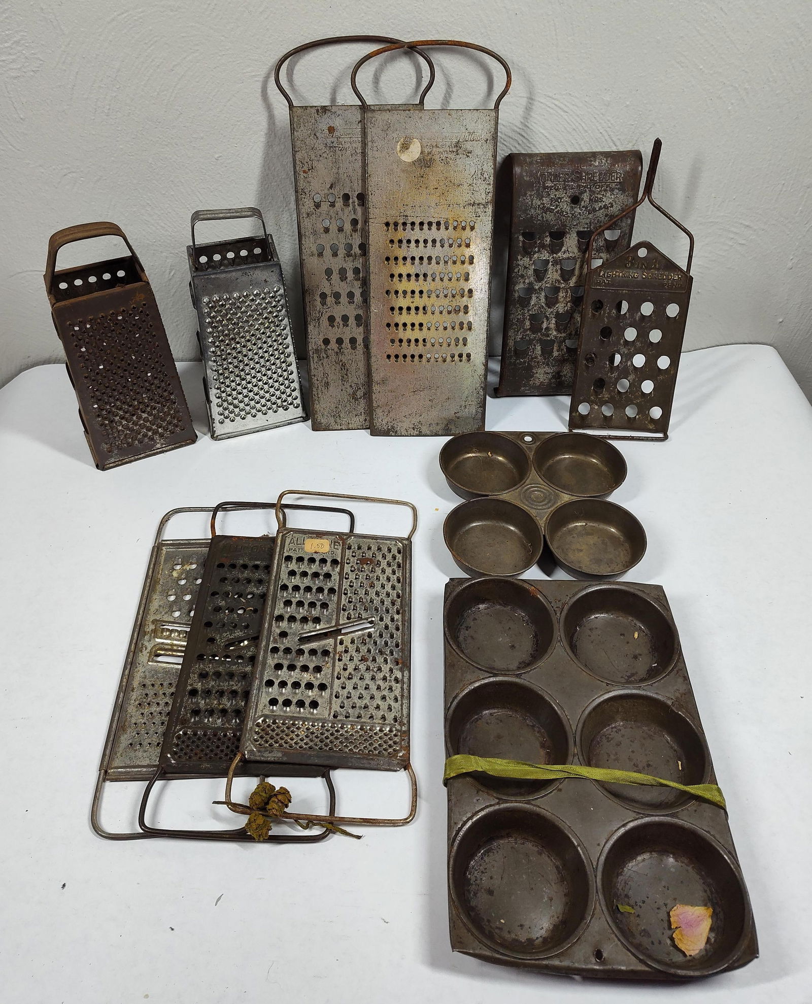 Tin Graters & Muffin Pans: Several early hand held shredders