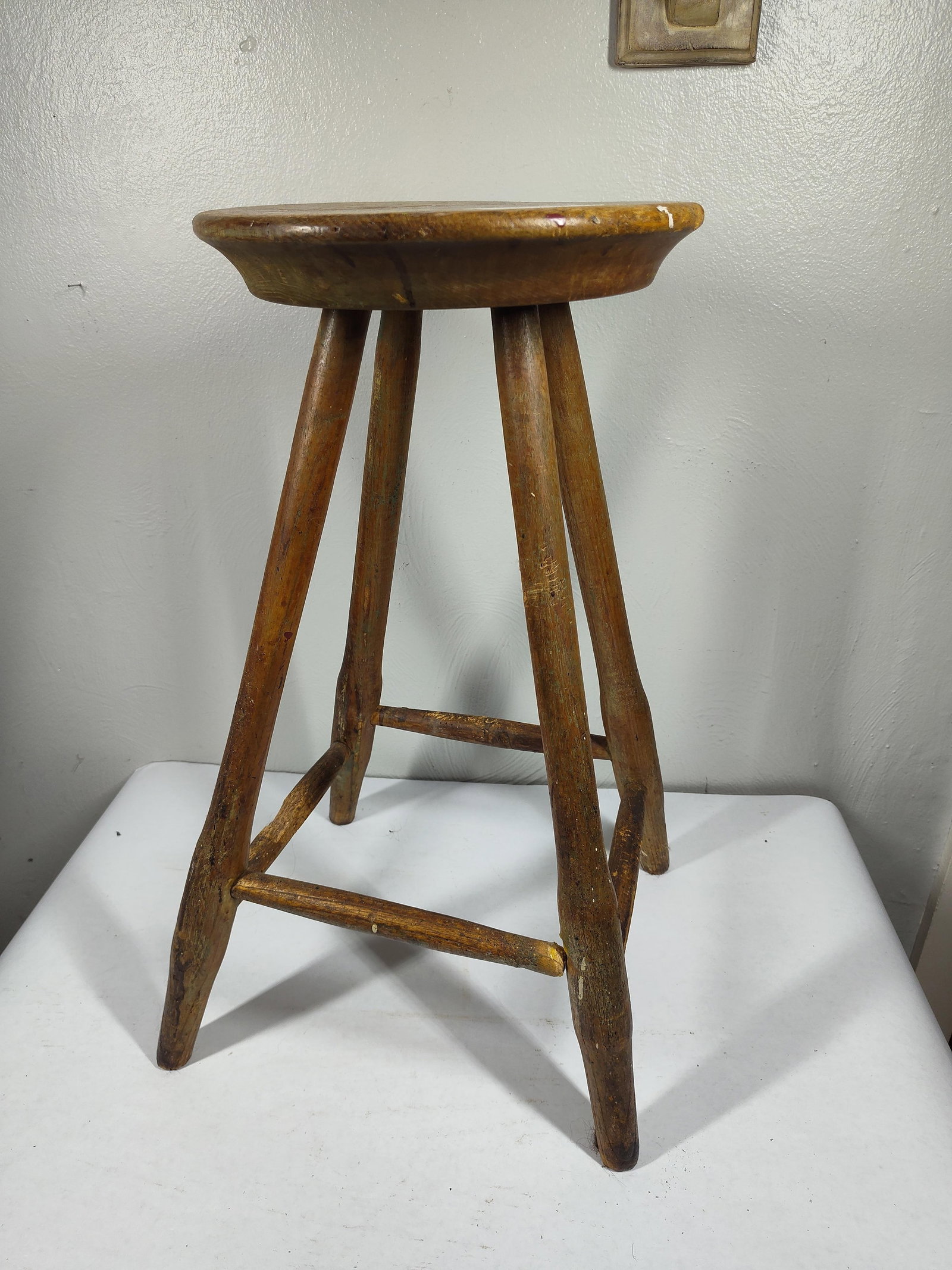 Hand Fashioned Shop stool: Wooden peg design, with a round top and great character. One spindle on bottom is unattached. 23 inches tall